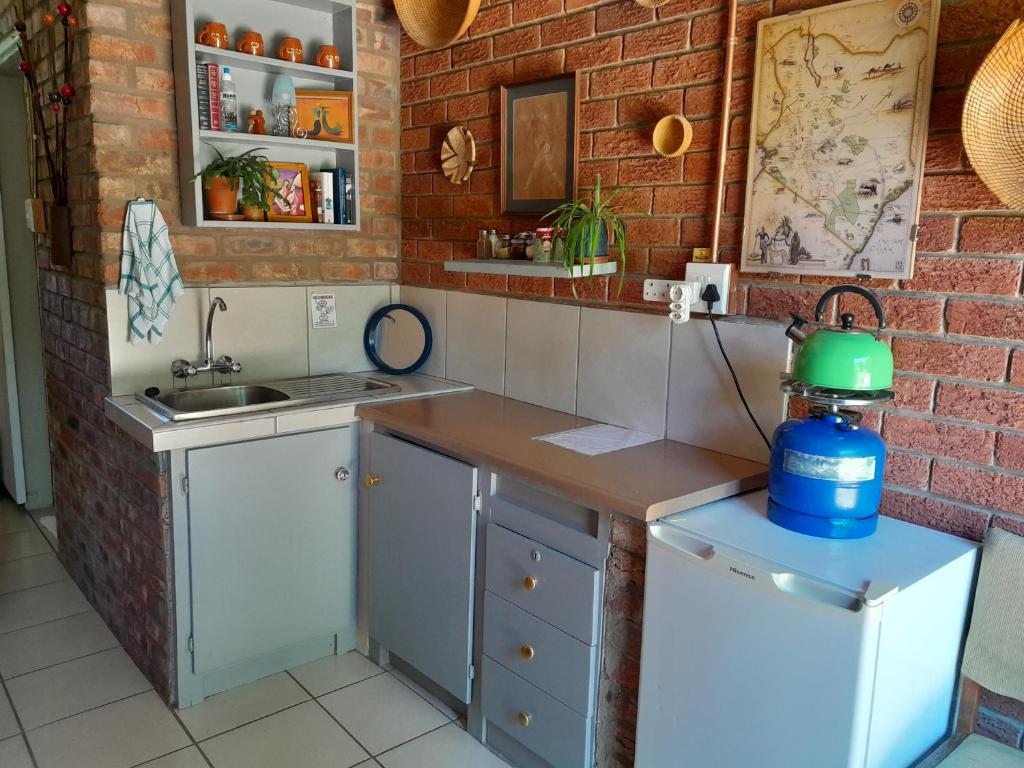a kitchen with a sink and a counter with a blender at Amani Guest house Clarens in Clarens