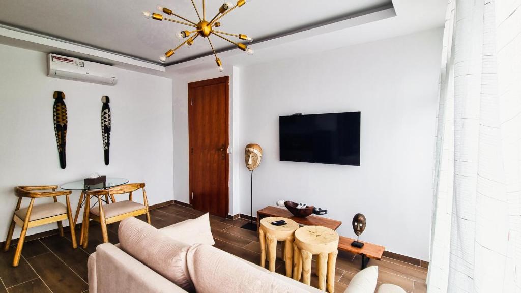 a living room with a couch and a table at Signal Appartments in Abidjan