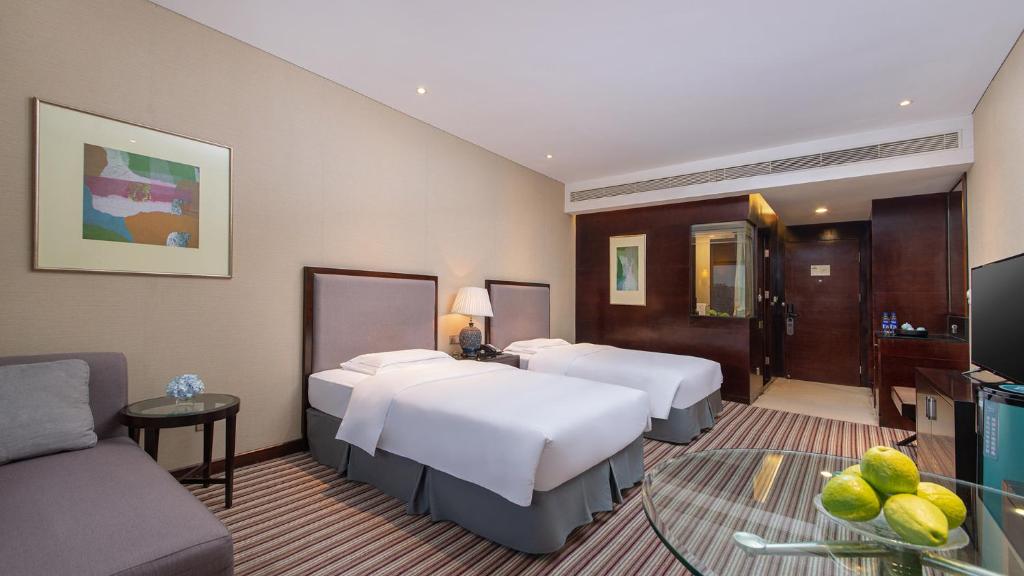 Postel nebo postele na pokoji v ubytování Binbei Yiho Hotel