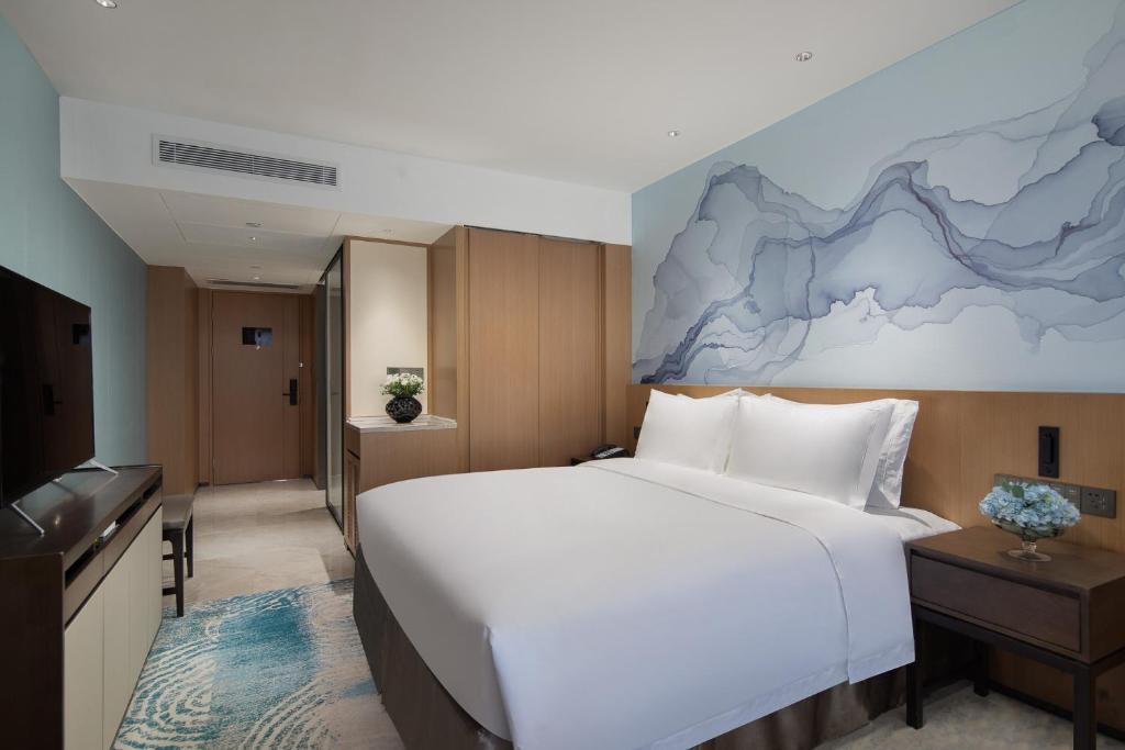 Postel nebo postele na pokoji v ubytování Foreign Trade Centre C&D Hotel,Fuzhou