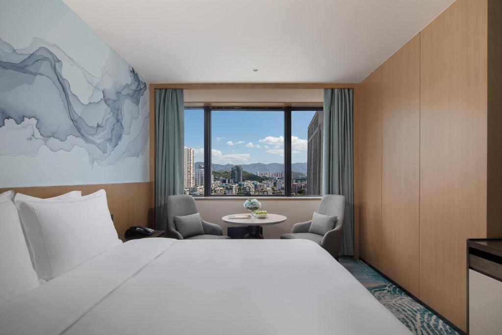Postel nebo postele na pokoji v ubytování Foreign Trade Centre C&D Hotel,Fuzhou