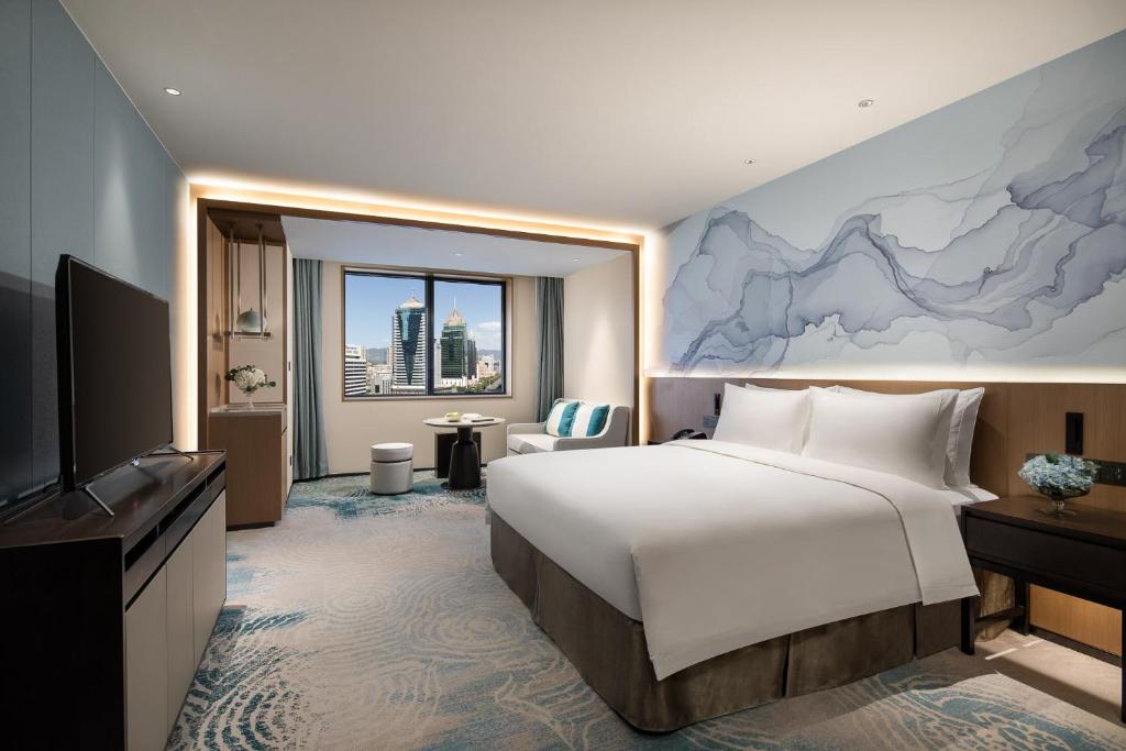 Postel nebo postele na pokoji v ubytování Foreign Trade Centre C&D Hotel,Fuzhou