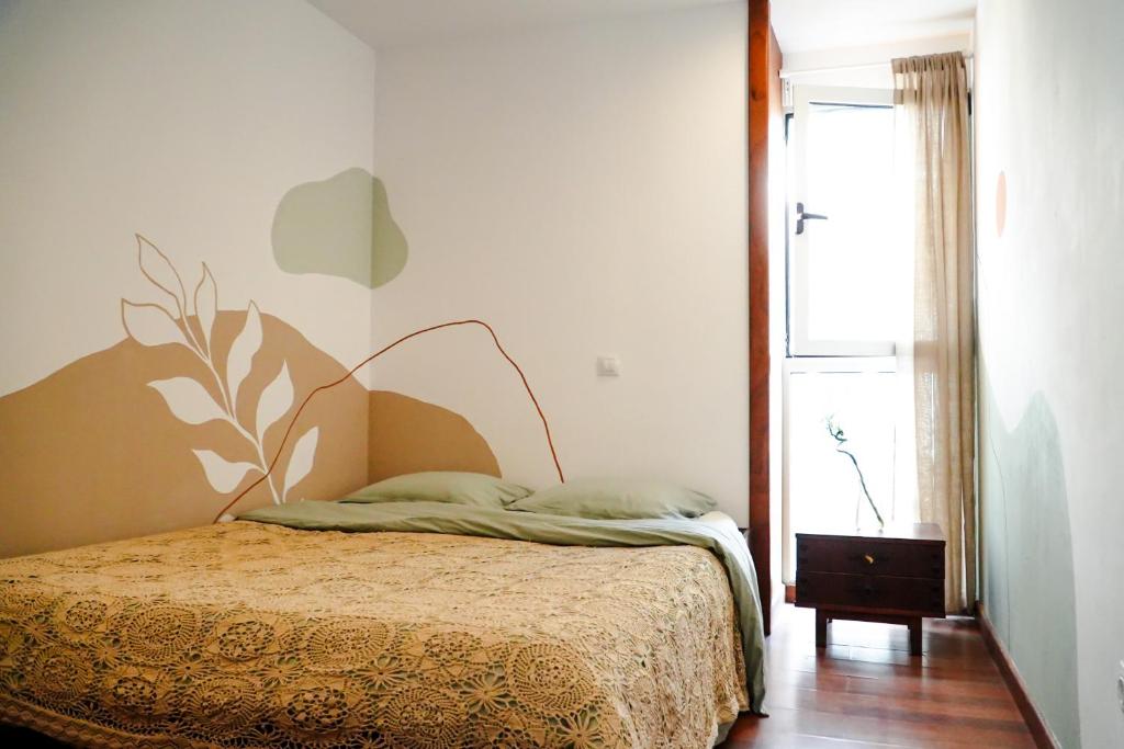 a bedroom with a bed and a window at Tamaran House in Las Palmas de Gran Canaria
