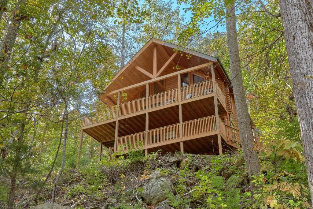 a tree house in the middle of the woods at A Tranquility Den #210 in Pigeon Forge