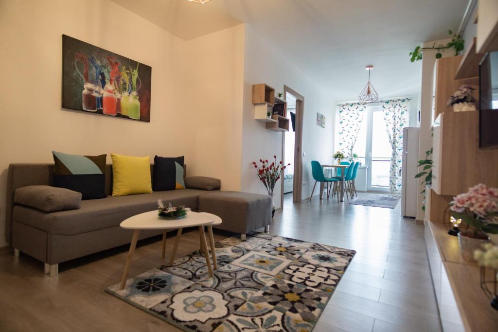 a living room with a couch and a table at Azure Home in Cluj-Napoca