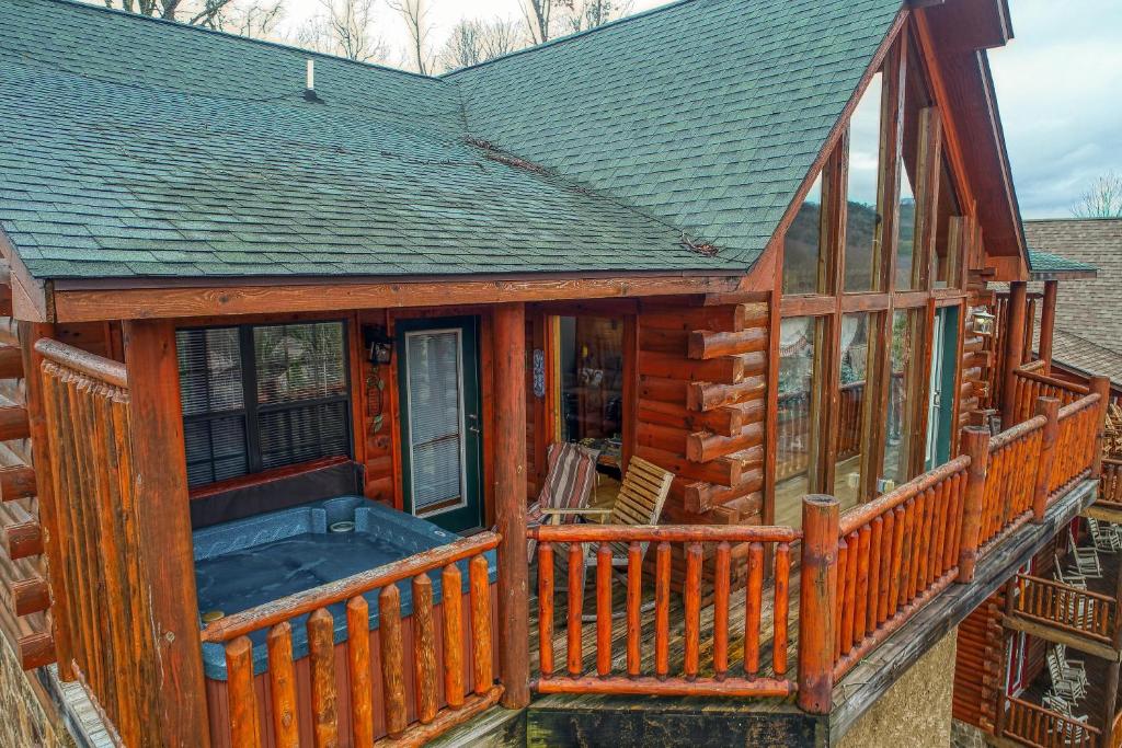 a log cabin with a wrap around porch at Kissing Retreat #269 in Sevierville