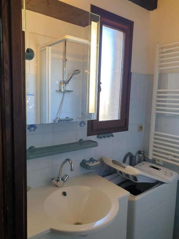 a bathroom with a sink and a mirror at Studio Mezzanine vue port et mer in La Londe-les-Maures