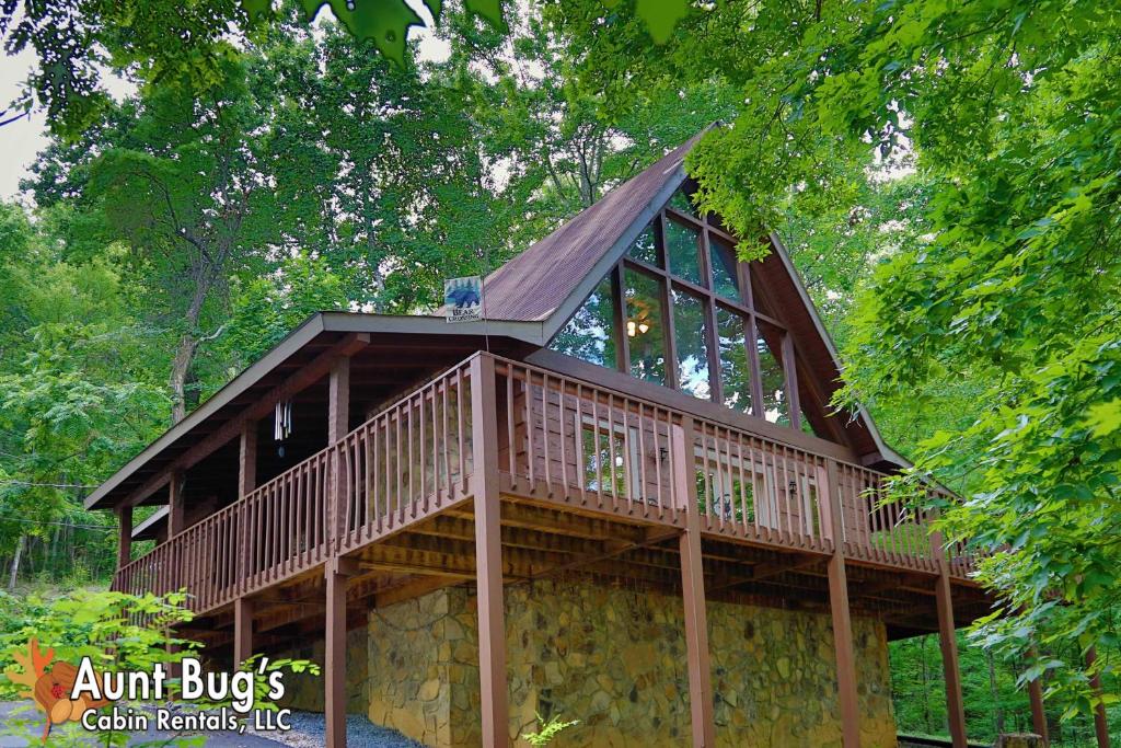 a tree house with a wrap around deck at A Secluded Retreat #216 in Pigeon Forge