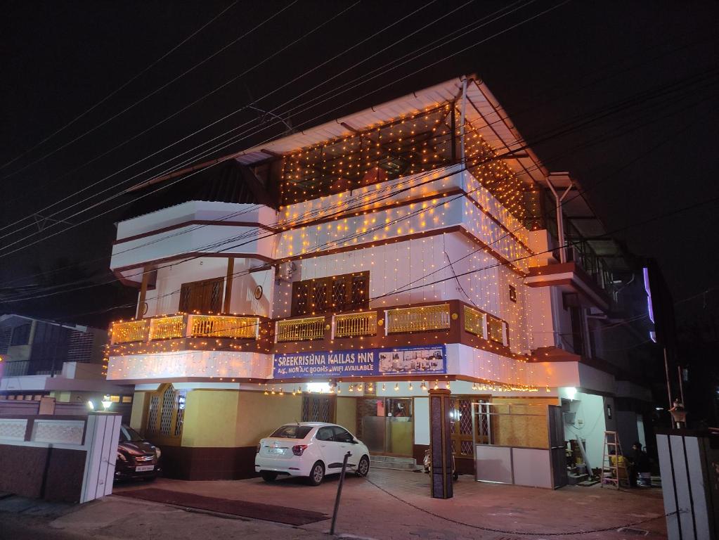 a building with a car parked in front of it at Krishna Kailas in Guruvāyūr