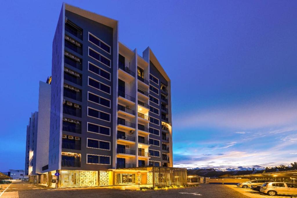 a tall building with cars parked in a parking lot at Imperio Professional Suite by 188AOR in Alor Setar