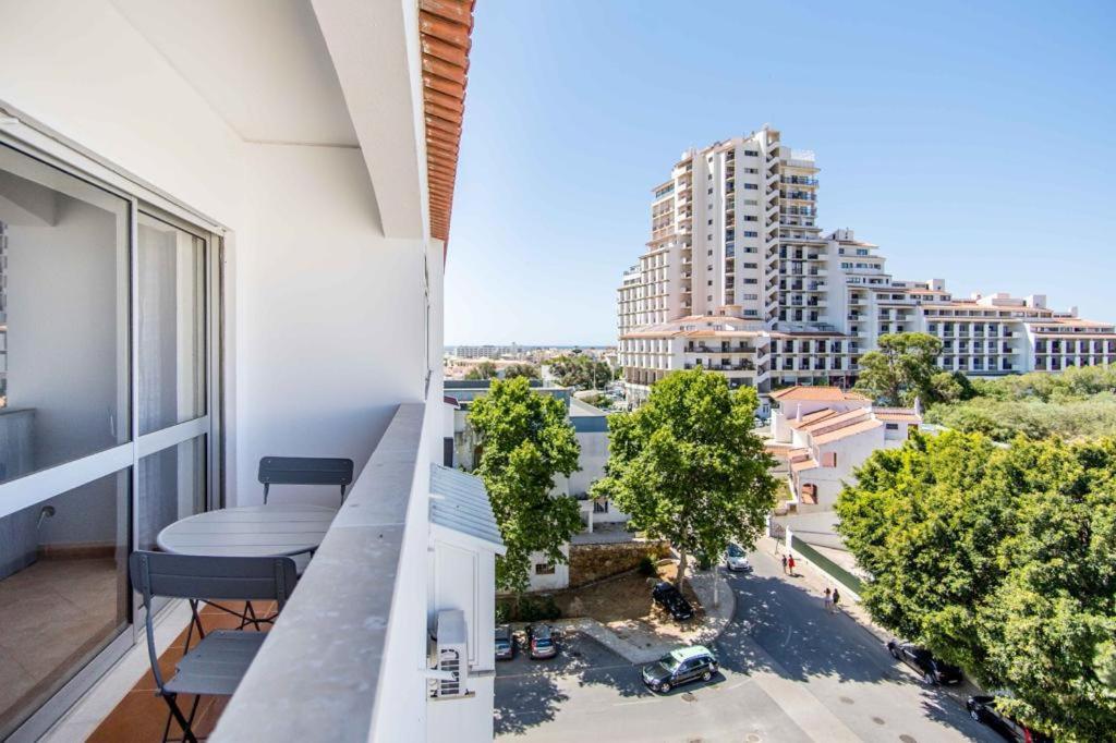 an apartment balcony with a view of a city at Albufeira Holidays Near The Strip in Albufeira