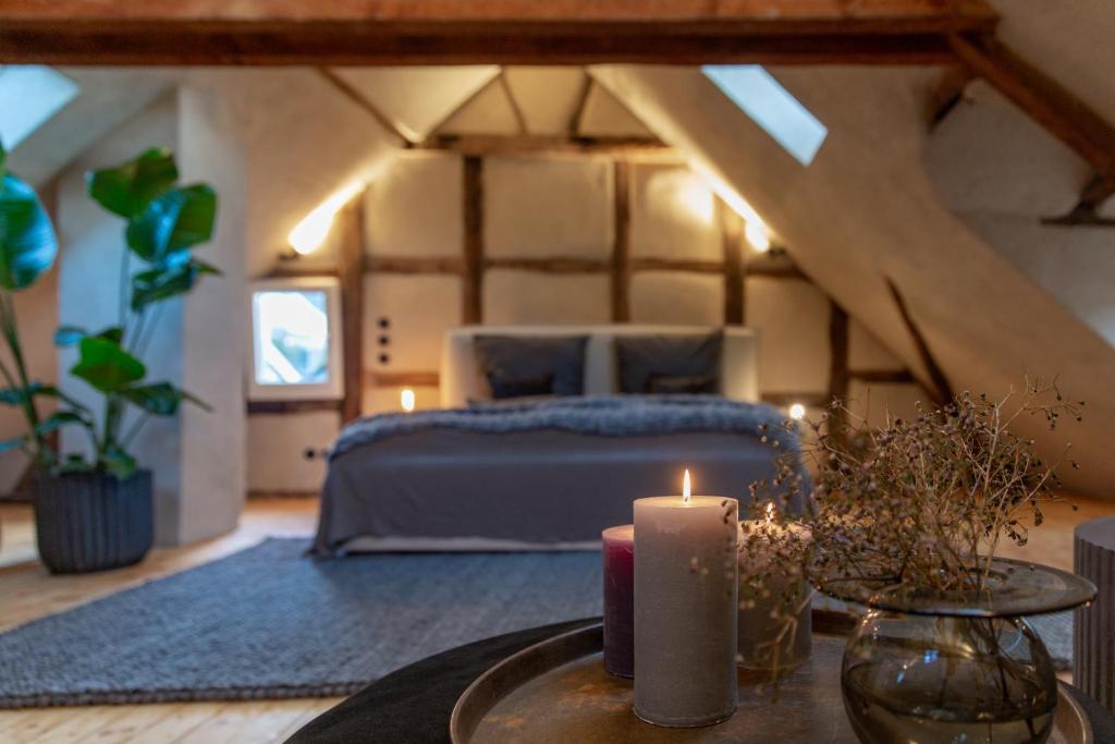 um quarto com uma cama e uma vela sobre uma mesa em N5Quartier em Bad Münstereifel