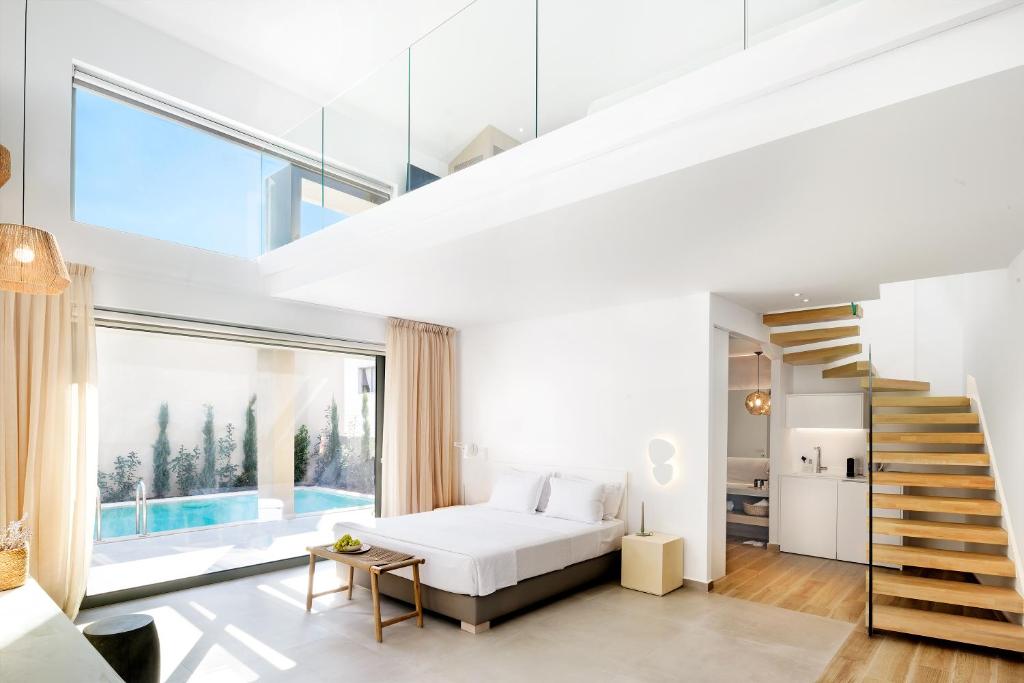 A bed or beds in a room at Cavo Delea Villas & Suites