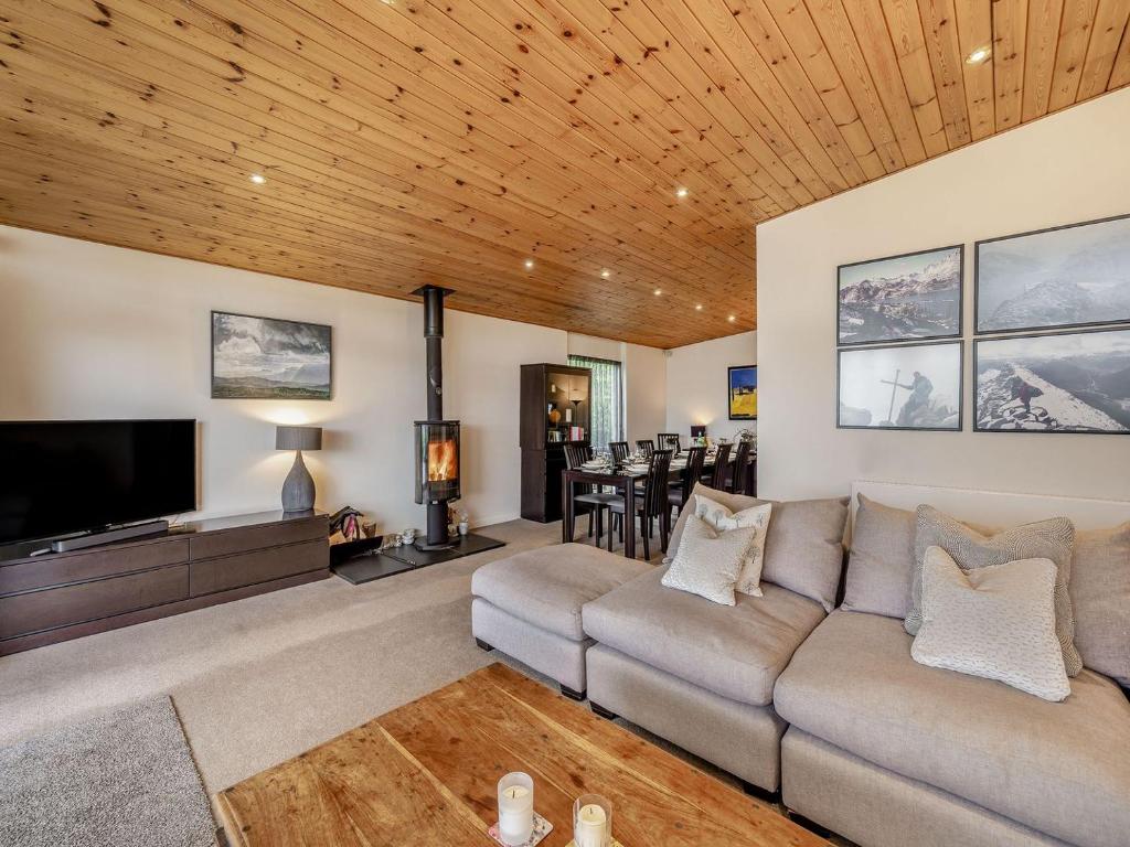 a living room with a couch and a tv at Homewood in Far Sawrey