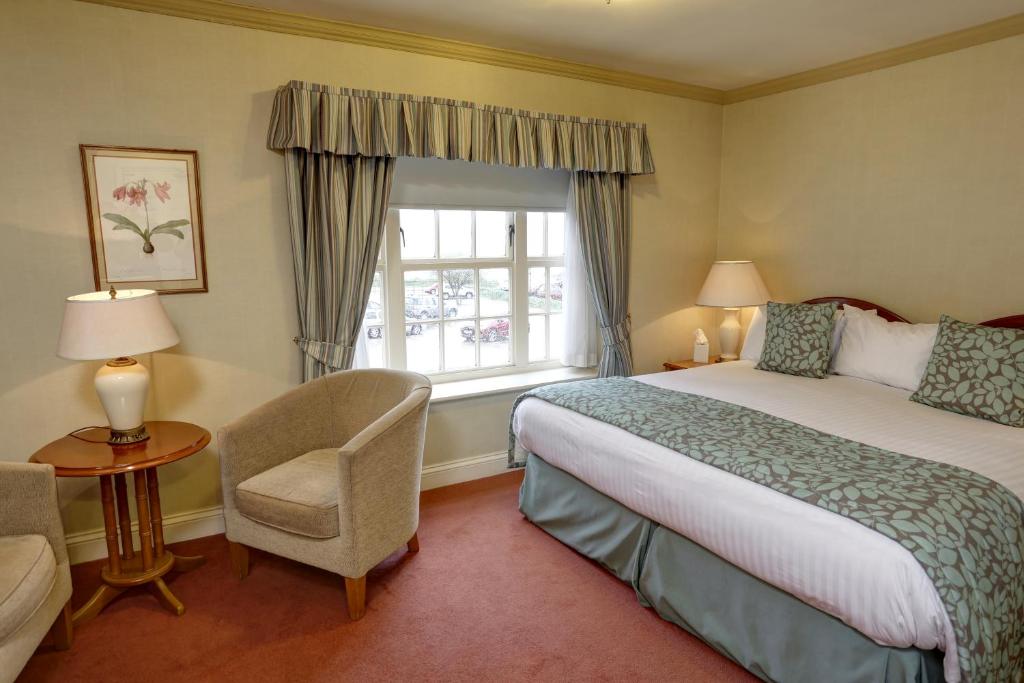 a hotel room with a bed and a window at Old Hunstanton Le Strange Arms Hotel in Hunstanton
