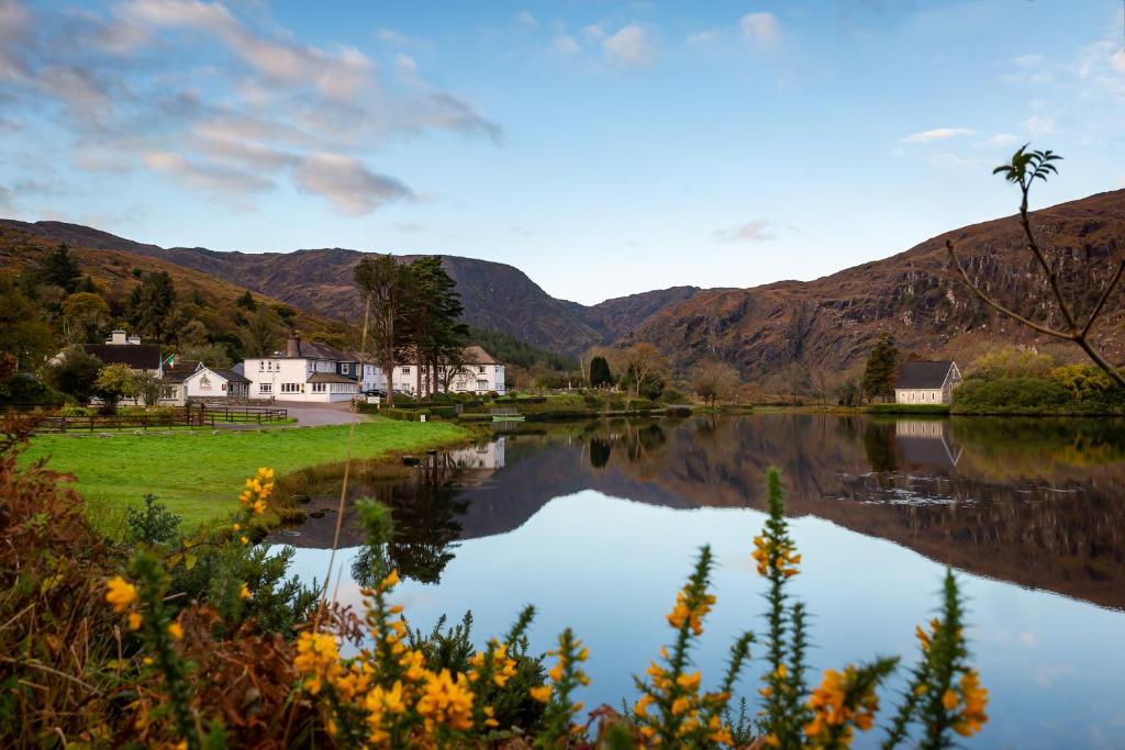 a view of a lake with mountains in the background at Gougane Barra Hotel in Ballingeary