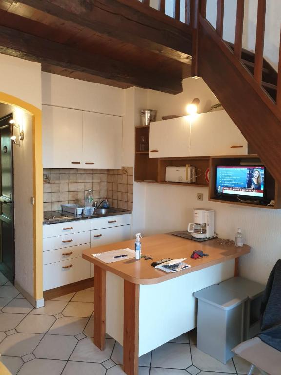 a kitchen with a wooden table in a room at Studio Mezzanine vue port et mer in La Londe-les-Maures