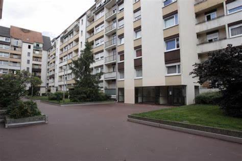 a large apartment building with a courtyard in front of it at Centre ville de Colmar avec Parking Downtown Colmar with Parking in Colmar