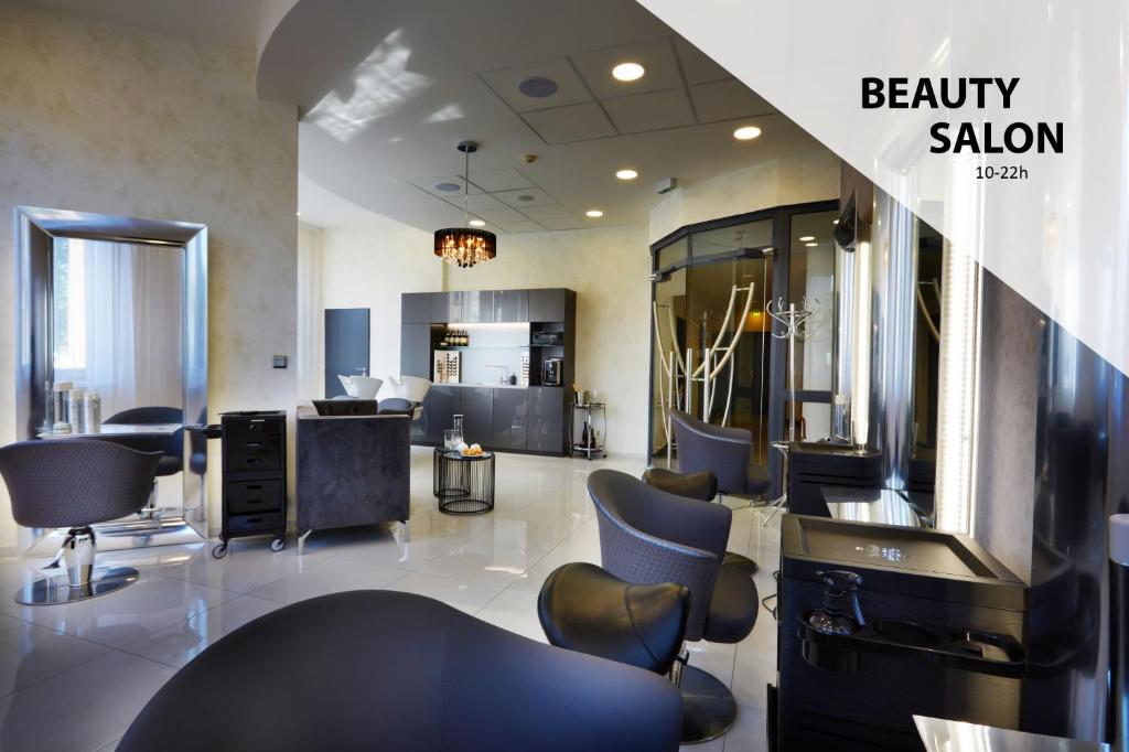a beauty salon with blue chairs and a mirror at Don Giovanni Hotel Prague - Great Hotels of The World in Prague