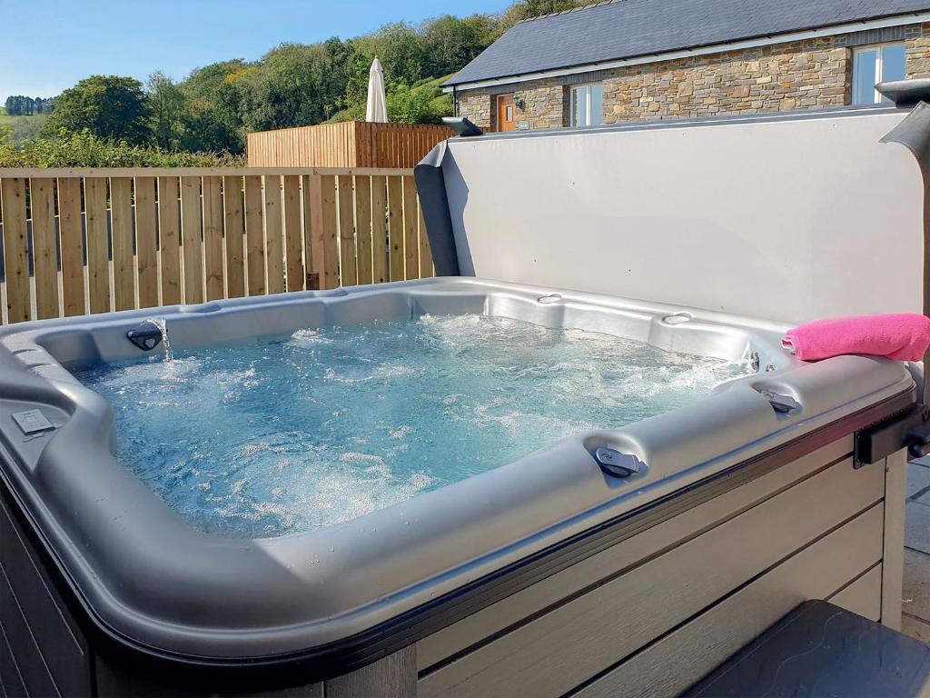 a jacuzzi tub in a backyard at Cartws-oh3 in Dihewid