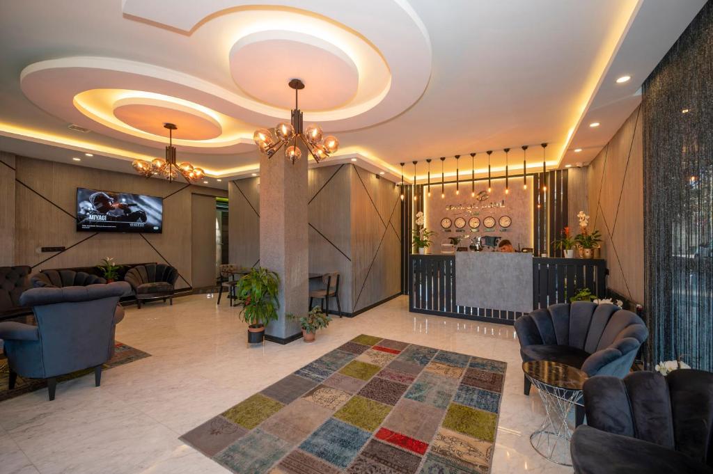 a lobby with a bar with chairs and a table at Comfort Point Hotel in Istanbul