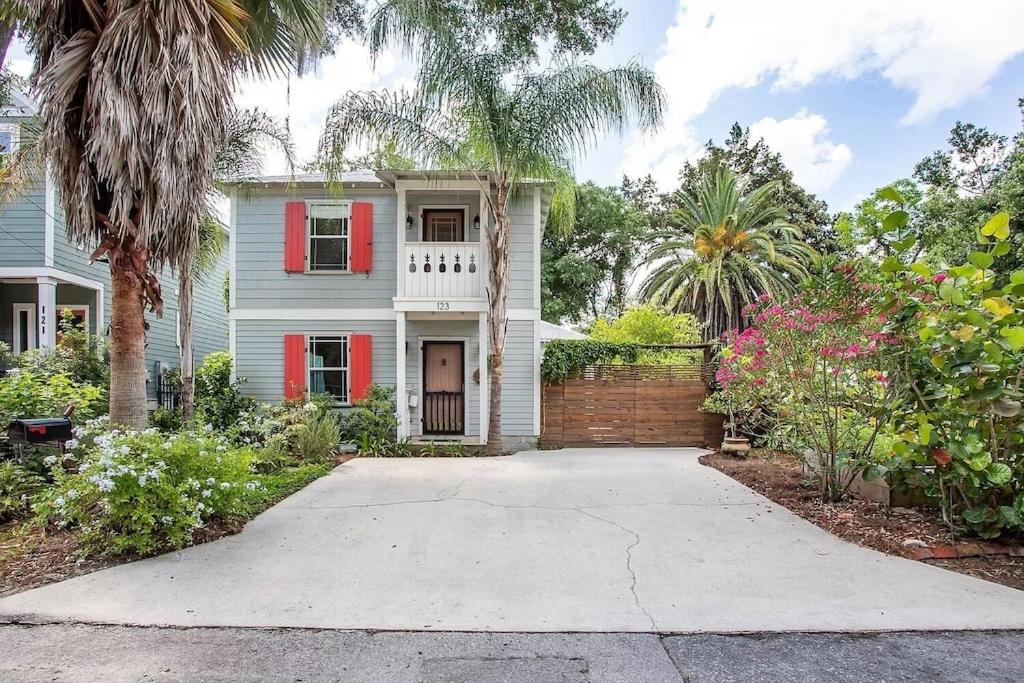 a house with a palm tree and a driveway at Luxurious indoor/outdoor Family Paradise in downtown St Augustine in St. Augustine