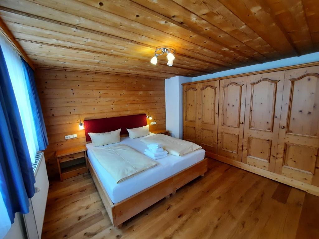 a bedroom with a bed in a wooden room at Ferienwohnung Drexel in Steeg