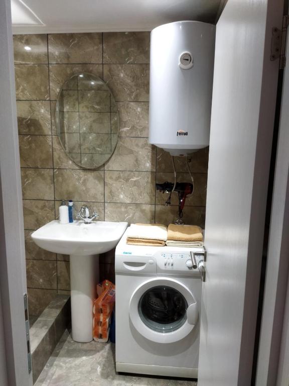 um banheiro com máquina de lavar e pia em TOP view Apartment Budva em Budva