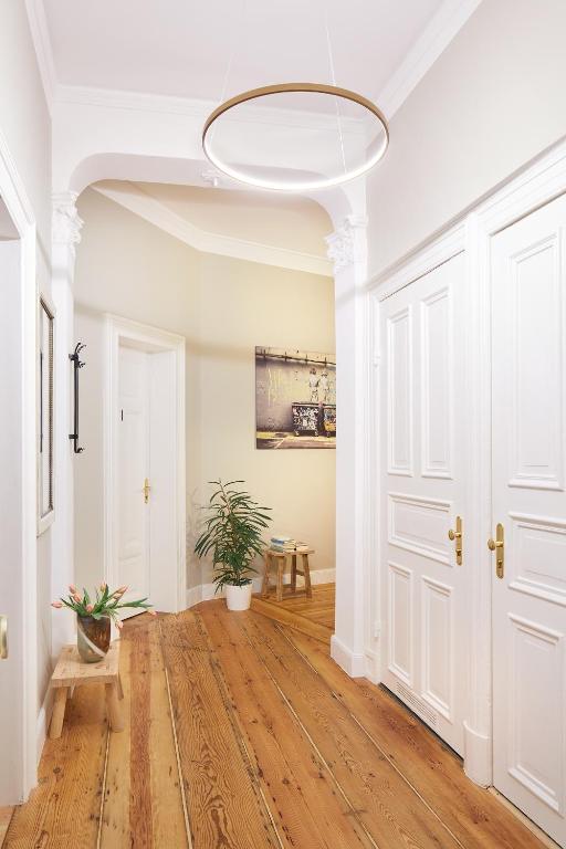 a hallway with a white door and a potted plant at Aparthotel alsterSuite in Hamburg