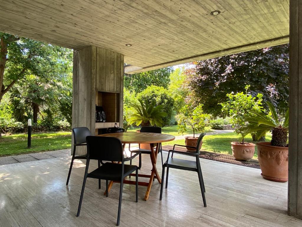 a wooden table and chairs on a patio at Holiday home Punta D'Oro with garden, parking place and lake access at 300 m in Iseo