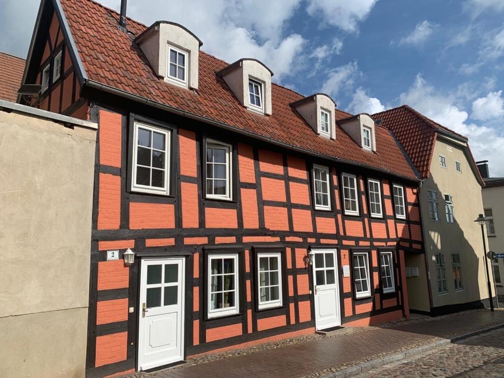 a brown and white building with white doors at UsedomTor 1720 FeWo II in Wolgast