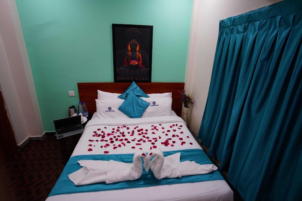 una camera da letto con un letto con due scarpe sopra di The Central Suites Vizag a Visakhapatnam