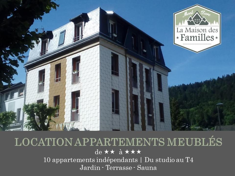 a building with a sign that reads location applications institutes institutes institutes buildings at La Maison des Familles 10 appartements in Le Mont-Dore