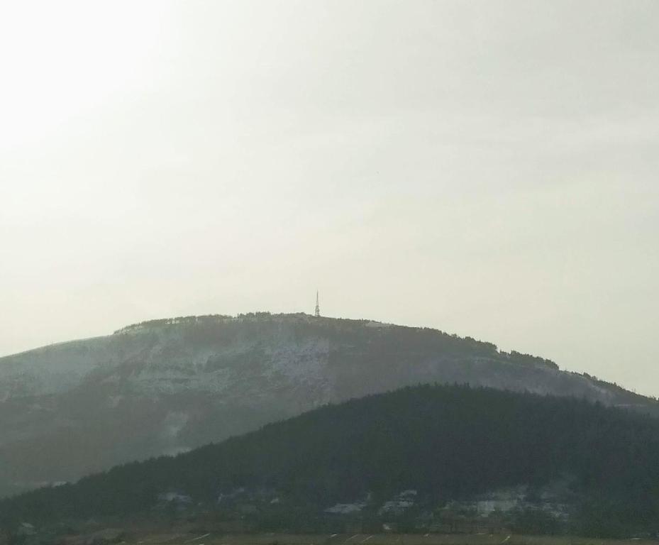 a mountain with a cross on top of it at Apartament Rita in Godziszka