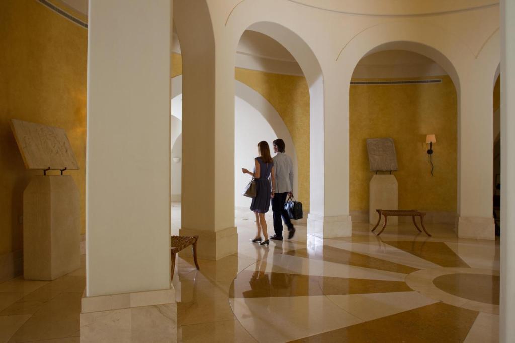 two people standing in a hallway in a building at Anassa in Polis Chrysochous