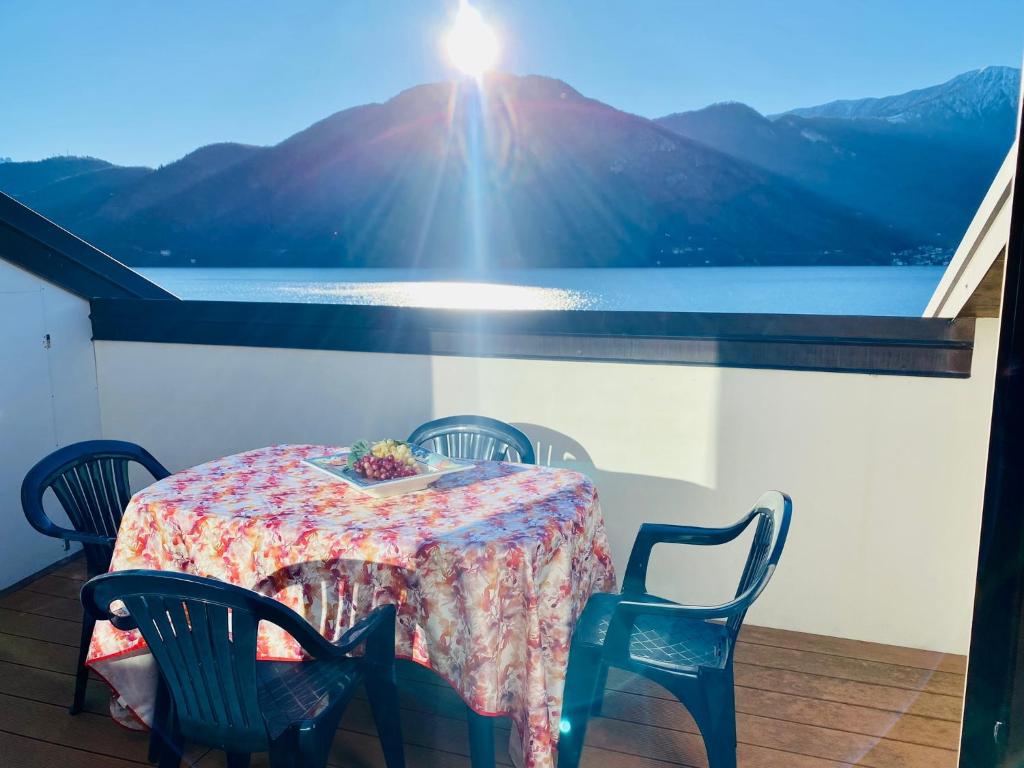 a table and chairs with a view of a mountain at ANGELO Loft in Tremezzo