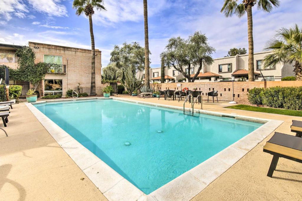 a swimming pool at a resort with palm trees at Scottsdale Condo about 2 Mi to Downtown! in Scottsdale