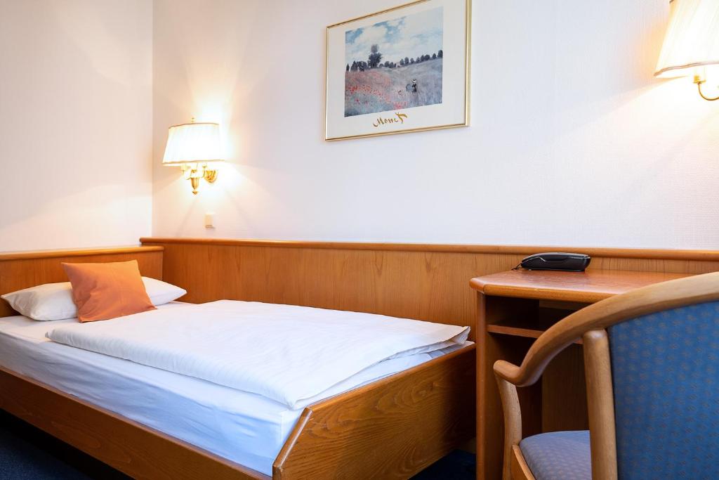 Postel nebo postele na pokoji v ubytování Hotel Am Steinberg