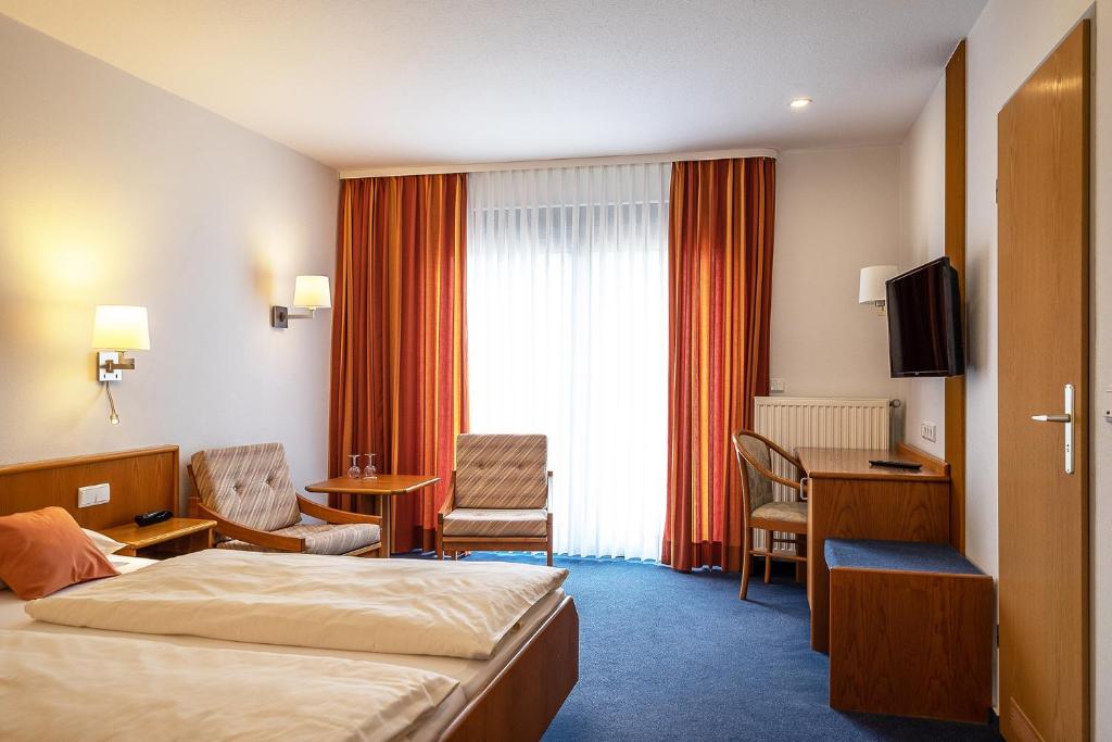 Postel nebo postele na pokoji v ubytování Hotel Am Steinberg