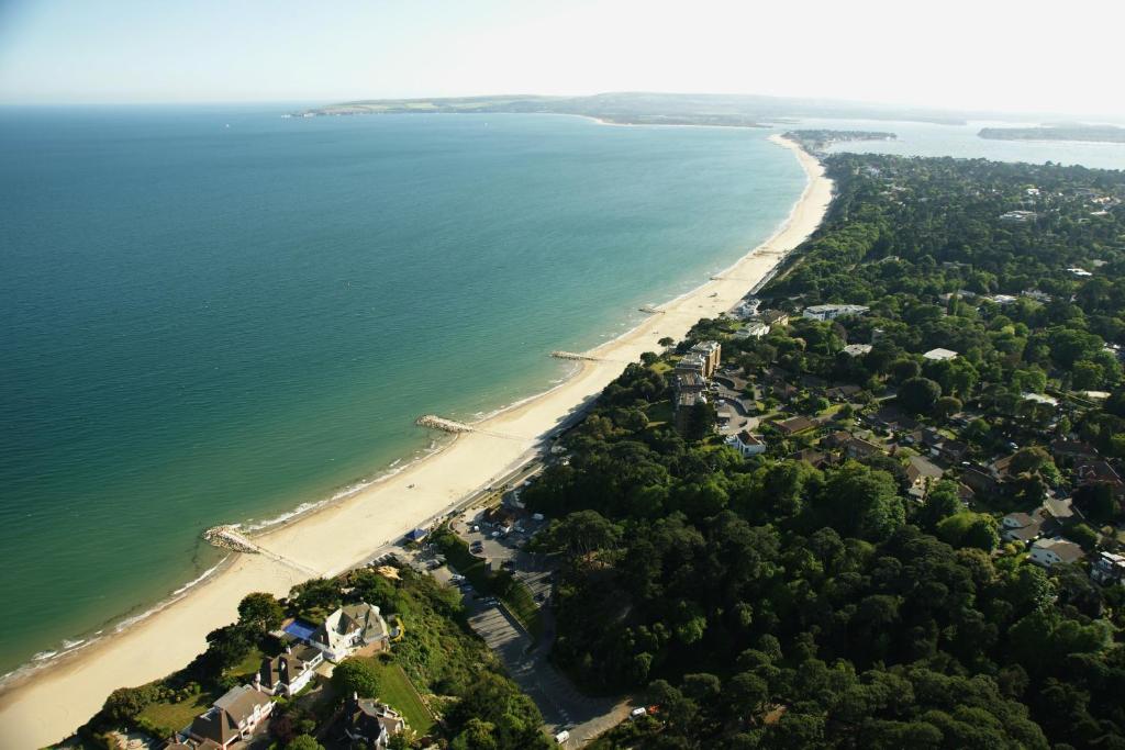 an aerial view of a beach and the ocean at The Canford in Poole