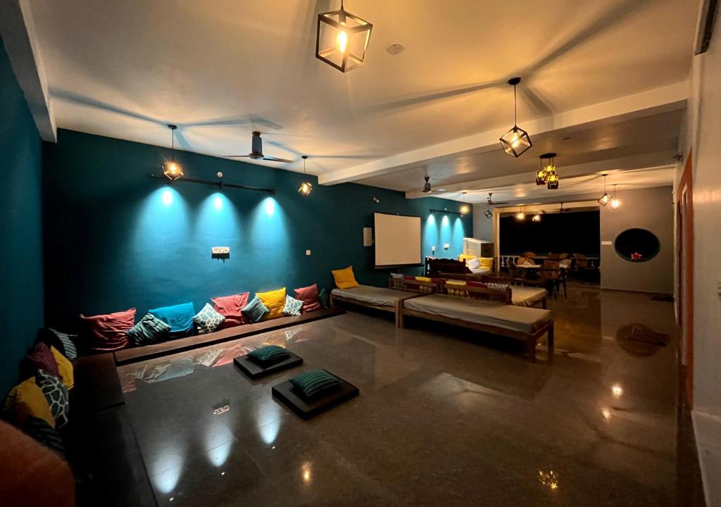 a living room with a couch and a table at Unearth Hostel (Pondicherry) in Auroville