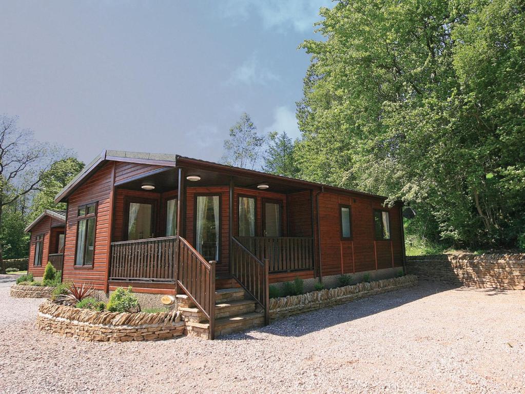 a wooden cabin with a porch and a deck at The Elms - E4306 in Brough