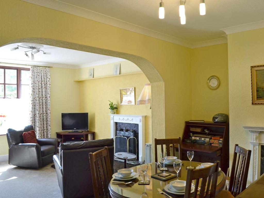 a living room with a table and a fireplace at High Bank in Bunbury