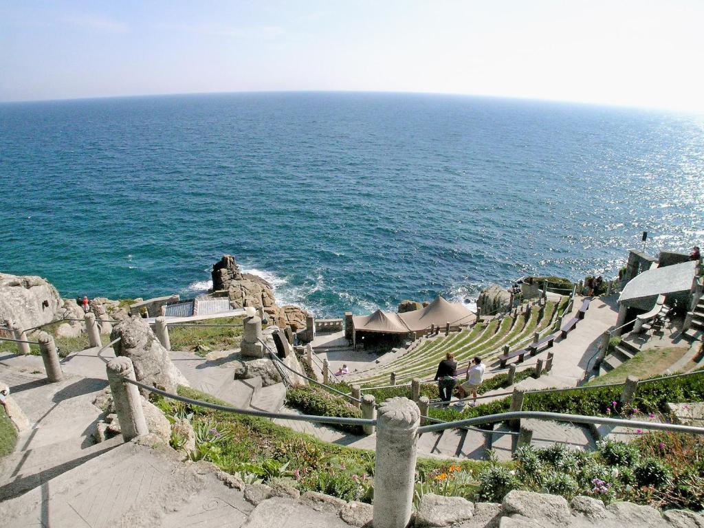 a group of stairs next to the ocean at Bowji in St. Just