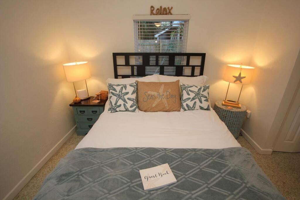 a bedroom with a bed with a sign on it at Cute Lil Oasis on Osprey in Sarasota