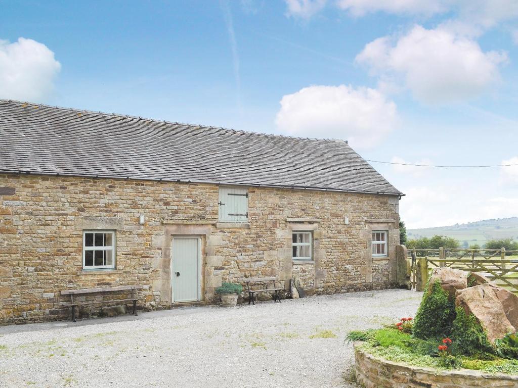 an old stone barn with a white door at Boosley Grange - E5372 in Newtown