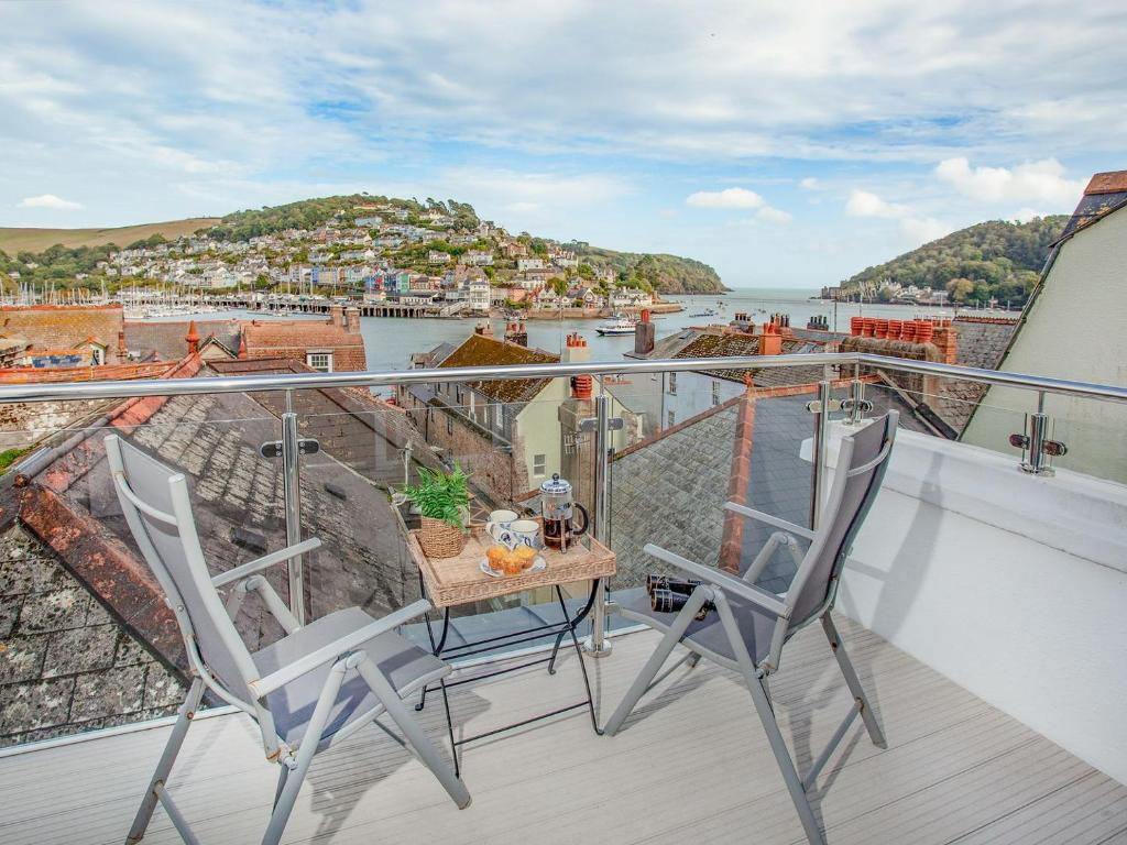 a balcony with two chairs and a table with a view at Dartview in Dartmouth