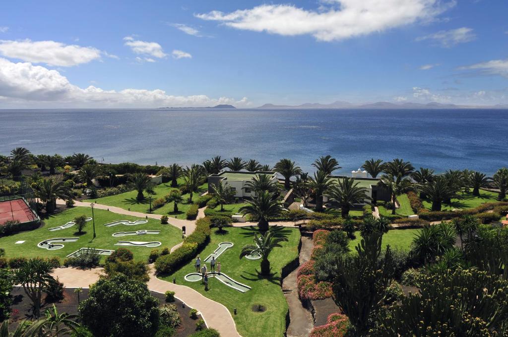 an aerial view of a resort with the ocean in the background at Hipotels Natura Palace Adults Only in Playa Blanca