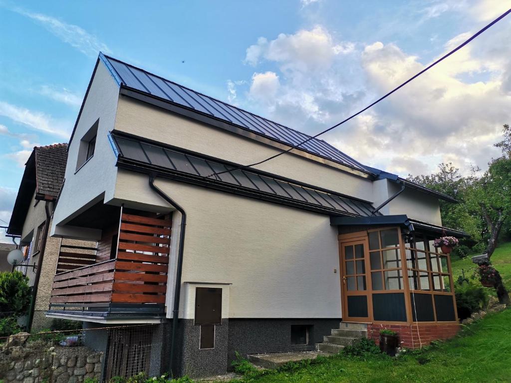 a house with solar panels on the side of it at Ubytovanie Liptov in Liptovský Michal