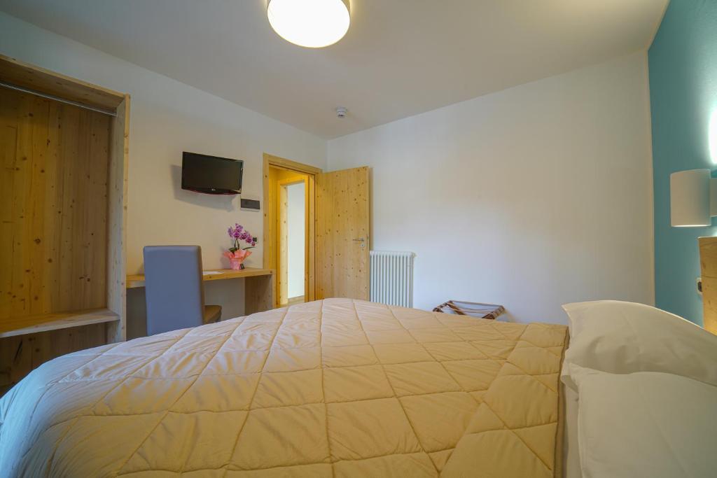 Postel nebo postele na pokoji v ubytování GH Hotel Monzoni